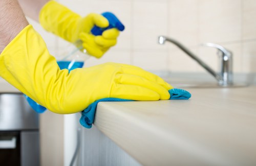Cleaner restoring a stone floor surface in a Battersea property